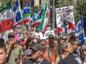 Protesters march to express their disagreement with Quebec's vaccination passport, which they are calling "highly discriminatory," in Montreal on Aug. 14, 2021.