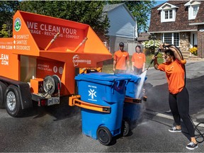 With the adoption of recycling and compost curb side pickup years ago, homes now have three waste bins — garbage, recycling and compost. Kirkland-based Curbside Clean's Mike Homsy, left, and Mel Vandersluis, centre, and Sam Homsy, right, use a pickup truck with a customized trailer to clean waste bins.
