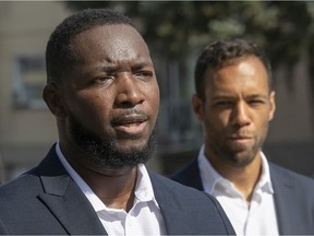 Movement Montreal leader Balarama Holness stands behind Carl-Henry Jean-François, his party's candidate for borough mayor in Montreal North, on Aug. 26, 2021.