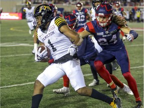 MONTREAL, QUE.: AUGUST 27, 2021 --  Montreal Alouettes Marc-Antoine Dequoy forces Hamilton Tiger Cats Frankie Williams out of bounds during Canadian Football League game in Montreal Friday August 27, 2021. (John Mahoney / MONTREAL GAZETTE) ORG XMIT: 66594 - 8238