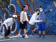 A group of children hold impromptu races in the school yard at Bancroft Elementary School in Montreal, on Aug. 31, 2020.