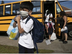 Musa Muhammad arrives for first day of school at St. Monica Elementary in N.D.G. on Tuesday. Ensuring high vaccination numbers in the general population will be key in preventing viral transmission in schools, Christopher Labos writes.