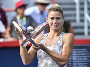 Camila Giorgi of Italy poses with the winner's trophy after defeating Karolina Pliskova of the Czech Republic during her women's singles final match on Day Seven of the National Bank Open on Aug. 15, 2021 in Montreal.