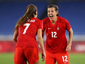 YOKOHAMA, JAPAN - AUGUST 06: Christine Sinclair #12 of Team Canada celebrates with Julia Grosso #7 following their team's victory in the penalty shoot out in the Women's Gold Medal Match between Canada and Sweden on day fourteen of the Tokyo 2020 Olympic Games at International Stadium Yokohama on August 06, 2021 in Yokohama, Kanagawa, Japan.