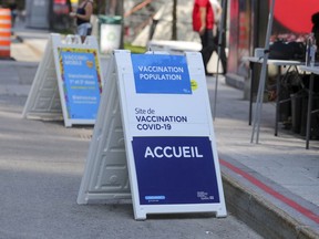 Signs advertising a mobile vaccination clinic in Place des Festivals operated by the CIUSSS Centre-Sud de Montréal Sunday August 8, 2021.