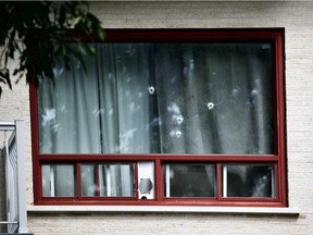 Bullet holes are visible from the street after a St-Léonard triplex was targeted with gunfire Friday morning. Police are investigating the scene.
