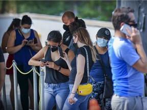 People line up for COVID-19 tests at the testing centre outside Montreal's Jewish General Hospital on Aug. 20, 2021.