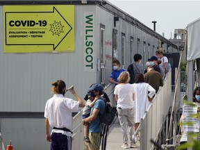 People line up for COVID-19 tests at the testing centre outside the Jewish General Hospital in Montreal on Aug. 20, 2021.