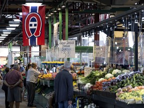 A Montreal Canadiens flag hangs from the rafters at Jean Talon Market in Montreal, on Monday, August 2, 2021.