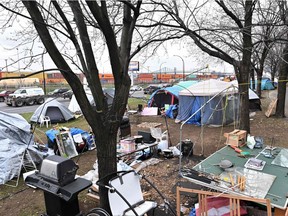A homeless camp, set up in the summer of 2020, lines a busy Montreal boulevard in November 2020.