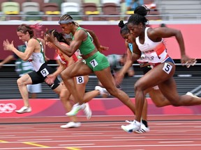 (From the right) Britain's Asha Philip, Nigeria's Blessing Akagbare and Belarus' Krystsina Tsimanouskaya compete in the women's 100m heats during the Tokyo 2020 Olympic Games at the Olympic Stadium in Tokyo on July 30, 2021.
