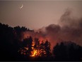 A forest fire ravages the village of Gouves on Evia island on Tues., Aug. 10. Nearly 900 firefighters were deployed on Greece's second largest island as major towns and resorts remained under threat from a fire that has been burning for nine days.