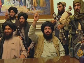 An image taken from Al Jazeera television on August 16, 2021 shows members of the Taliban taking control of the presidential palace in Kabul after Afghanistan's president flew out of the country.