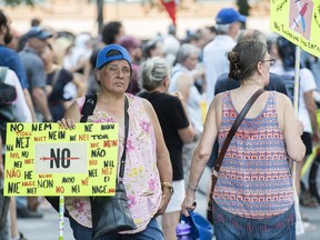 People attend a demonstration against measures put in place by the Quebec government to help curb the spread of COVID-19, in Montreal, Saturday, Aug. 21, 2021.