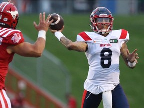 Montreal Alouettes quarterback Vernon Adams Jr. throws a pass as Calgary Stampeders' Isaac Adeyemi-Berglund defends during first half in Calgary on Aug. 20, 2021.