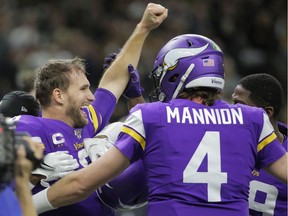Minnesota Vikings quarterback Kirk Cousins (left) celebrates with teammates after defeating the New Orleans Saints in overtime of a NFC Wild Card playoff football game at the Mercedes-Benz Superdome in New Orleans on Jan. 5, 2020.