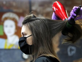 Changing the shape of hair requires disruption of the various bonds responsible for the keratin structure, Joe Schwarcz writes. Above: An employee of the London Inn salon, in Kazan, Russia, dries the hair of a customer.