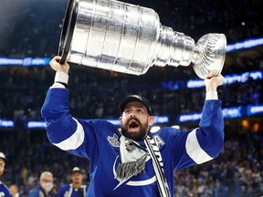 Tampa Bay Lightning left wing Alex Killorn (17) hoists the Stanley Cup after the Lightning defeated the Montreal Canadiens 1-0 in game five to win the 2021 Stanley Cup Final at Amalie Arena. (Kim Klement-USA TODAY Sports TPX IMAGES OF THE DAY)