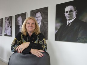 Elisabeth Ann Laett, Holt Xchange’s managing partner, is seen in front of portraits of the Holt family at the company’s office last week.
