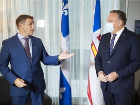 Quebec Premier François Legault, right, speaks with Newfoundland and Labrador Premier Andrew Furey during a meeting in Montreal, Monday, August 30, 2021.