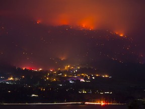 CP-Web. Flames are seen from the Christie Mountain wildfire along Skaha Lake near Penticton, B.C. Wednesday, August 19, 2020. Wildfires in the area have forced several thousand people to be on evacuation alert.