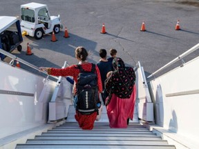 Afghan refugees who supported Canada's mission in Afghanistan arrive at Toronto Pearson International Airport in Canada, August 24, 2021.