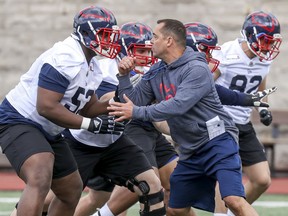 Montreal Alouettes assistant coach André Bolduc takes on offensive-lineman Jarvis Harrison during rookie camp in Montreal on May 15, 2019.