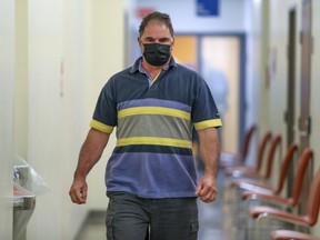 Co-accused Guy Dion walks through the hall during a break in his murder trial at the Gouin courthouse in Montreal on May 31, 2021.