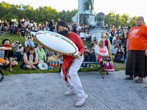 Lucy Tulugarjuk drums, sings and dances during a commemorative drumming session in Montreal on May 31, 2021, in memory of the 215 Indigenous children whose remains were found in a mass grave at a former residential school in Kamloops, B.C.