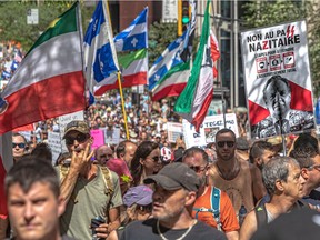 Protesters march to express their disagreement with Quebec's vaccination passport, which they are calling "highly discriminatory", in Montreal on Saturday August 14, 2021. Dave Sidaway / Montreal Gazette ORG XMIT: 66535