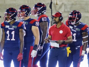 Montreal Alouettes head coach Khari Jones stands on the sideline with some of his players during Canadian Football League game against the Hamilton Tiger Cats in Montreal Friday August 27, 2021.