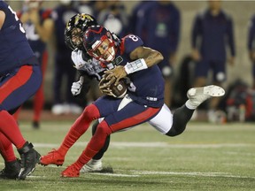 Montreal Alouettes quarterback Vernon Adams Jr. ducks under tackle attempt by Hamilton Tiger-Cats] Julian Howsare in Montreal on Aug. 27, 2021.