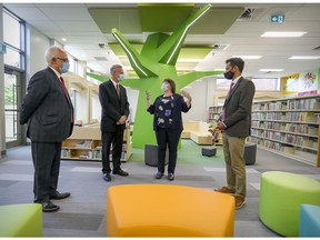 Dollard-des-Ormeaux library director Hélène Diamond gives a tour of the newly renovated library to Mayor Alex Bottausci, Robert-Baldwin MNA Carlos Leitão and Pierrefonds-Dollard MP Sameer Zuberi on Wednesday. A vaccine passport will not be required for libraries or museums.