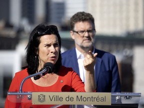 Montreal Mayor Valérie Plante speaks as Gatineau Mayor Maxime Pedneaud-Jobin looks on at a press conference in Montreal on Tuesday, Sept. 7, 2021. Conservative Leader Erin O'Toole's pledge to review the classification of 1,500 types of military-style assault weapons is "a step backwards," Plante says.