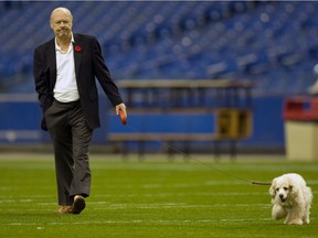 Robert Wetenhall walks his dog Three across the field following a Montreal Alouettes practice at the Olympic Stadium in 2008. “This man spent a lot of money out of his own pocket … just for people to have a good time," said former Als general manager Jim Popp.