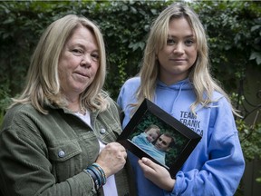 Kimmy Chedel, left, with her daughter Zoë Doyle holds a picture of her late husband, Frank Doyle, who died on 9/11. Zoë is the baby in the picture. "The anniversaries are always hard. I’d like to say that it gets easier, but it doesn’t," Chedel says.