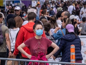 Xiang Li was waiting for a friend at the Ste-Catherine St. W. sidewalk sale in Montreal on Saturday, Sept. 11, 2021, so she struck a pose that she thought would stand out.