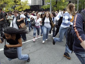 Bystanders rush away from Westmount Square at the corner of Wood Ave. and De Maisonneuve Bolvd. September 13, 2006 after reports of a second shooter in the mall. The people, many of them Dawson College students, were on the street having fled shooting rampage in the school.