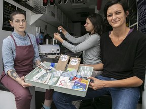 GRIP director Magali Boudon, right, with Kathryn Balind, centre, and Alexane Langevin with some of the products available to drug users from their new mobile drug testing van.