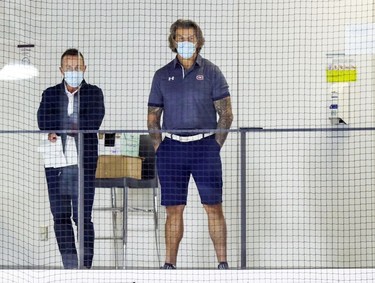 Montreal Canadiens general manager Marc Bergevin, right, watches the first day of rookie camp at the Bell Sports Complex in Brossard on Thursday, Sept. 16, 2021.