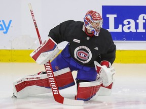 Canadiens goaltender Carey Price does some exercises on the ice under the supervision of a member of the team's training staff at the Bell Sports Complex in Brossard on Thursday.