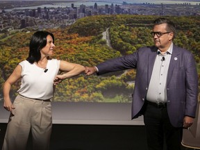 Projet Montréal leader Valérie Plante and Ensemble Montréal leader Denis Coderre greet one another at the start of a debate hosted by the Montreal tourism board on Sept. 23, 2021.