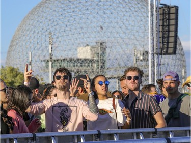 Anthony Pageau, left, Meriem Benzakour and Jasmin Petit dance to the beats of DJ Spencer Brown at the Île Soniq Redux electronic music festival at Parc Jean-Drapeau in Montreal on Friday, Sept. 24, 2021.