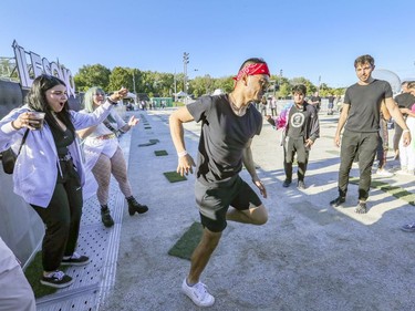 Fubin Yang dances to the beats of DJ Spencer Brown with a group of friends at the Île Soniq Redux electronic music festival at Parc Jean-Drapeau in Montreal on Friday, Sept. 24, 2021.