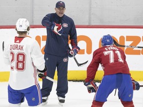 Christian Dvorak and Jake Evans listen as head coach Dominique Ducharme gives instructions during Canadiens' training camp Friday at the Bell Sports Complex in Brossard on Sept. 24.