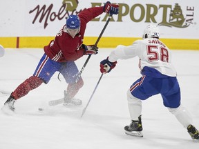Montreal Canadiens' Jake Evans battles David Savard during training camp in Brossard on Sept. 24, 2021.