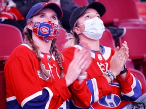 Two Habs fans cheers as the Montreal Canadiens are introduced for the annual Red vs White scrimmage in Montreal, on Sunday, Sept. 26, 2021.