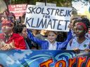Greta Thunberg lifts her climate strike sign during the Montreal march on Sept. 27, 2019. Governments must apply crisis management lessons learned from COVID-19 to the climate crisis, writes Allison Hanes.