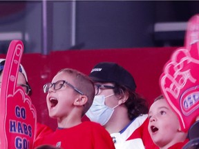 Young Habs fans cheer as the Montreal Canadiens are introduced for a Red vs. White scrimmage at the Bell Centre on Sept. 26, 2021.