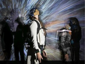 Allyson Brownie, front, uses augmented-reality gear as she walks through the new We Live in an Ocean of Air at the Phi Centre on Tuesday Sept. 28, 2021.